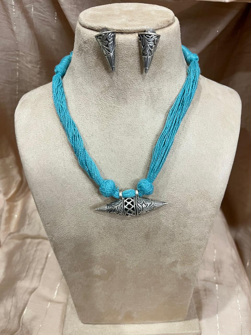 Silver replica pendant with cotton thread dori