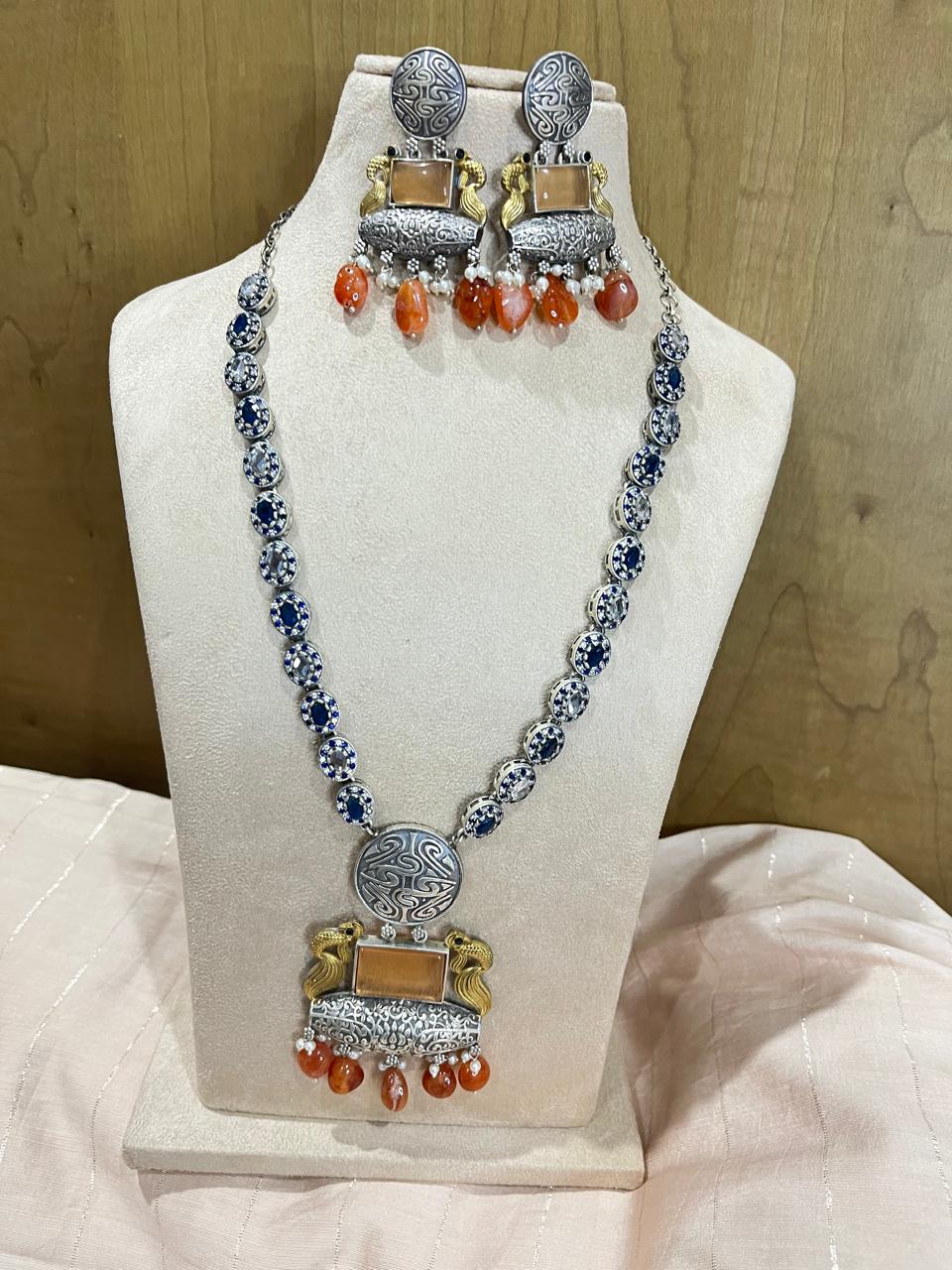 Dual tone stone studded long necklace with earrings