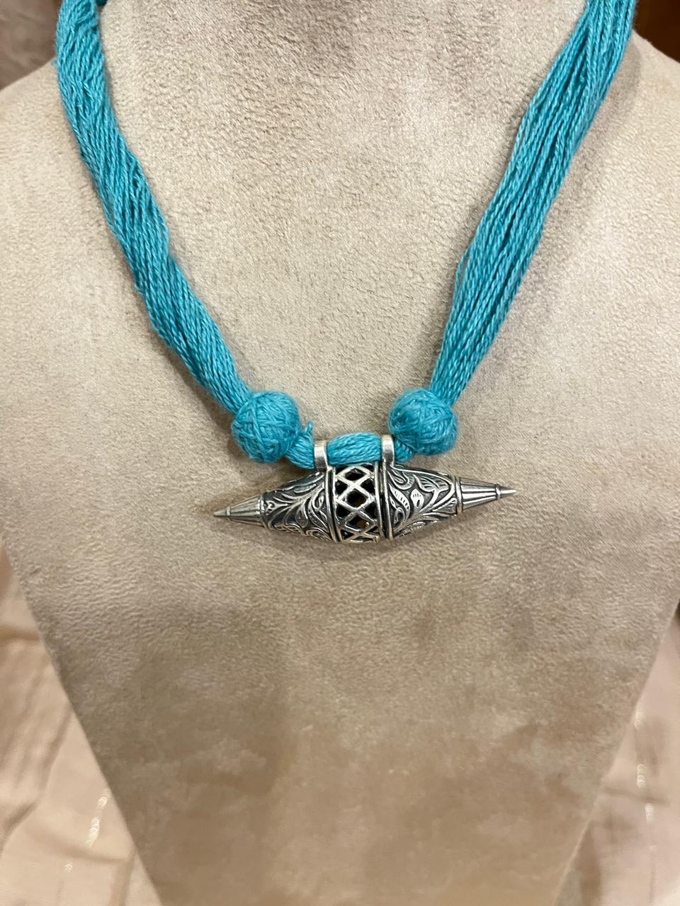 Silver replica pendant with cotton thread dori