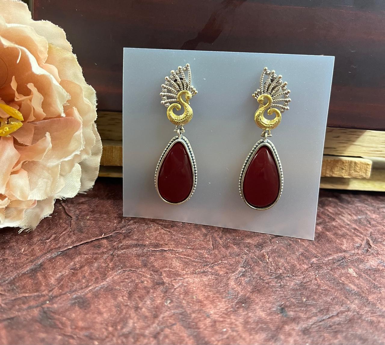 Stone studded dual tone tops earrings