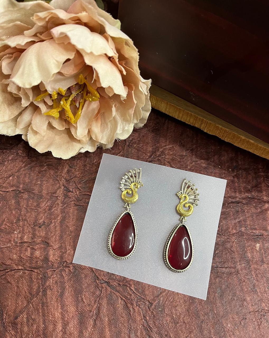 Stone studded dual tone tops earrings